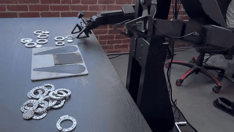 Almond’s Axol robot deburrs spacers used in its own assembly. Physical Intelligence presents this demonstration at 1× speed.