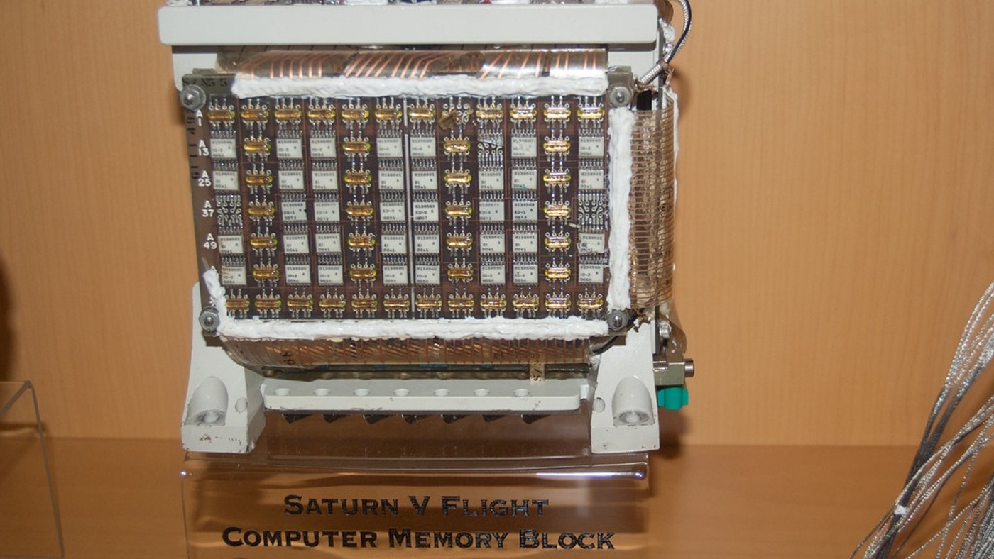 A Saturn V flight-computer memory block. Historical context for the distinction between storing information and deciding when to rewrite it.